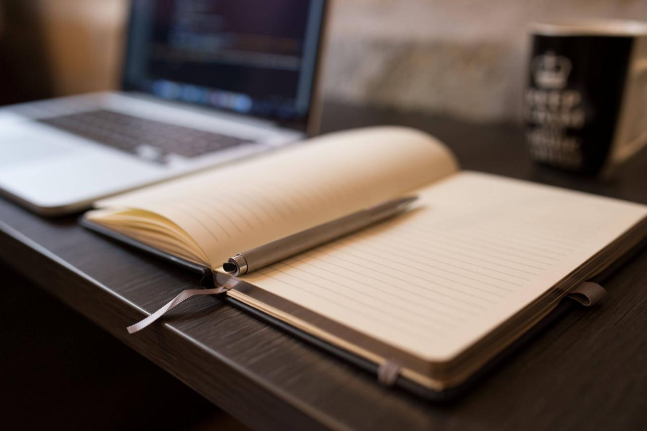 Taking notes in a notebook and on the laptop for dissertation hypothesis writing